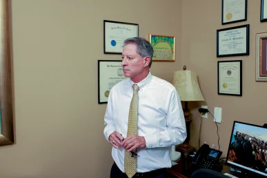 Tom mccutcheon and joel hamner meet with a client to talk through a catastrophic injury claim.