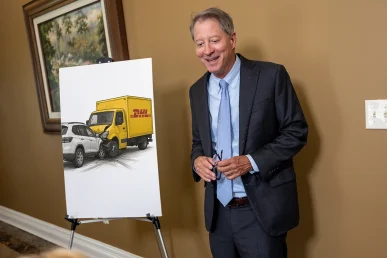 Tom mccutcheon consults with a client about a dhl delivery accident case.