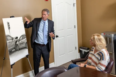 Tom mccutcheon consults with a client about a postmates accident claim.