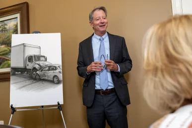 Tom mccutcheon consults with a client about a moving truck accident lawsuit.