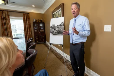Tom mccutcheon consults with a client about a pizza delivery accident case.