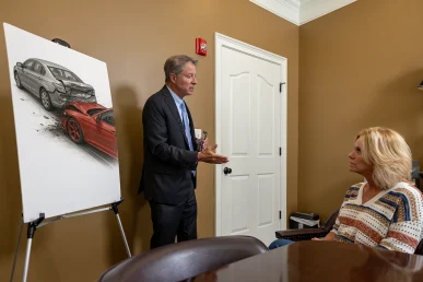Tom mccutcheon consults with a client about a speeding accident lawsuit.