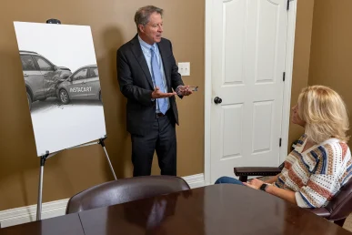 Tom mccutcheon consults with a client about an instacart accident claim.