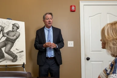 Tom mccutcheon consults with a client about an electrocution accident claim.