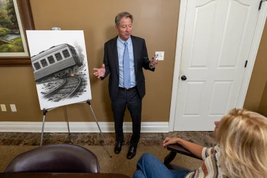 Tom mccutcheon discusses a train and light rail accident claim with a client.