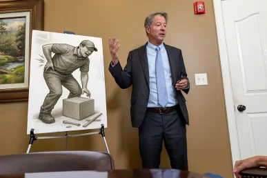 Tom mccutcheon meets with a client to evaluate a workers’ compensation claim.