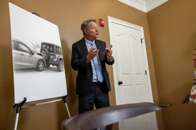 Tom mccutcheon meets with a client to examine a rear end crash claim.