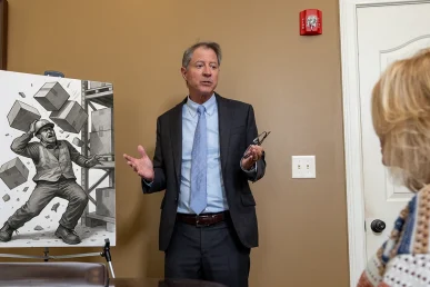 Tom mccutcheon meets with a client to review a falling object accident claim.