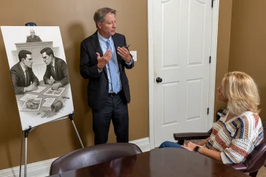 Tom mccutcheon meets with a client to review an insurance litigation claim.