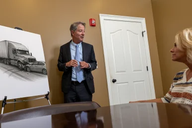 Tom mccutcheon reviews evidence with a client while evaluating a big rig accident lawsui.