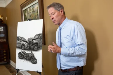 Tom mccutcheon talks with a client about a combined rideshare and food delivery accident lawsuit.