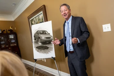Tom mccutcheon talks with a client about a hazardous roadway accident case.