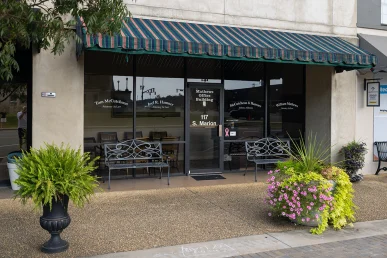 McCutcheon & Hammer law office in Athens, Alabama, features a prominent entrance with benches and flower planters.