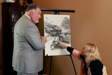 Attorney Joel Hamner discusses a drunk driving accident exhibit while examining a drawing depicting the scene in Athens,.