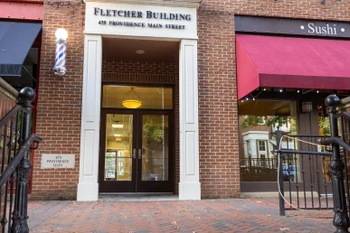 Fletcher Building entrance at 475 Providence Main Street, next to a sushi restaurant in Huntsville, Alabama.