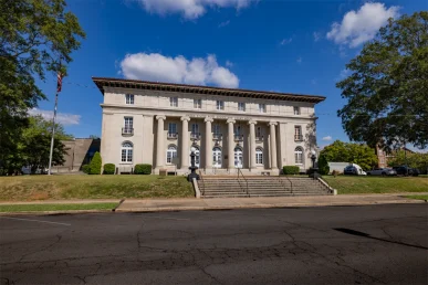 Historic Florence courthouse exterior on a bright blue sky day