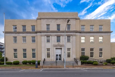 Historic Huntsville federal courthouse features a grand entrance with steps, large windows, and a prominent "United States.