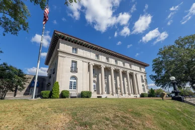 Florence Alabama courthouse seen through large trees in front