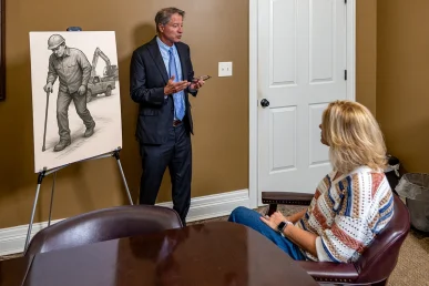 Tom McCutcheon with client discussing long term disability attorney Florence Alabama.