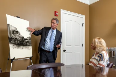 Tom McCutcheon talking with a client about truck accident law in Florence Alabama