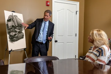 Tom McCutcheon talking with a client about wrongful death law in Florence Alabama