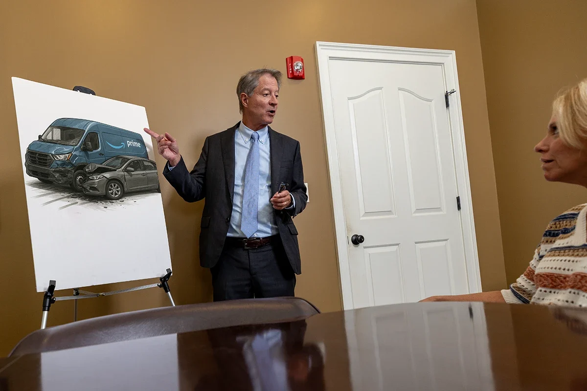Personal injury attorney tom mccutcheon meets with a client in the mccutcheon & hamner conference room to discuss an amazon prime delivery accident clai.